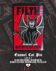 Enamel cat pin with red and black design on a dark background