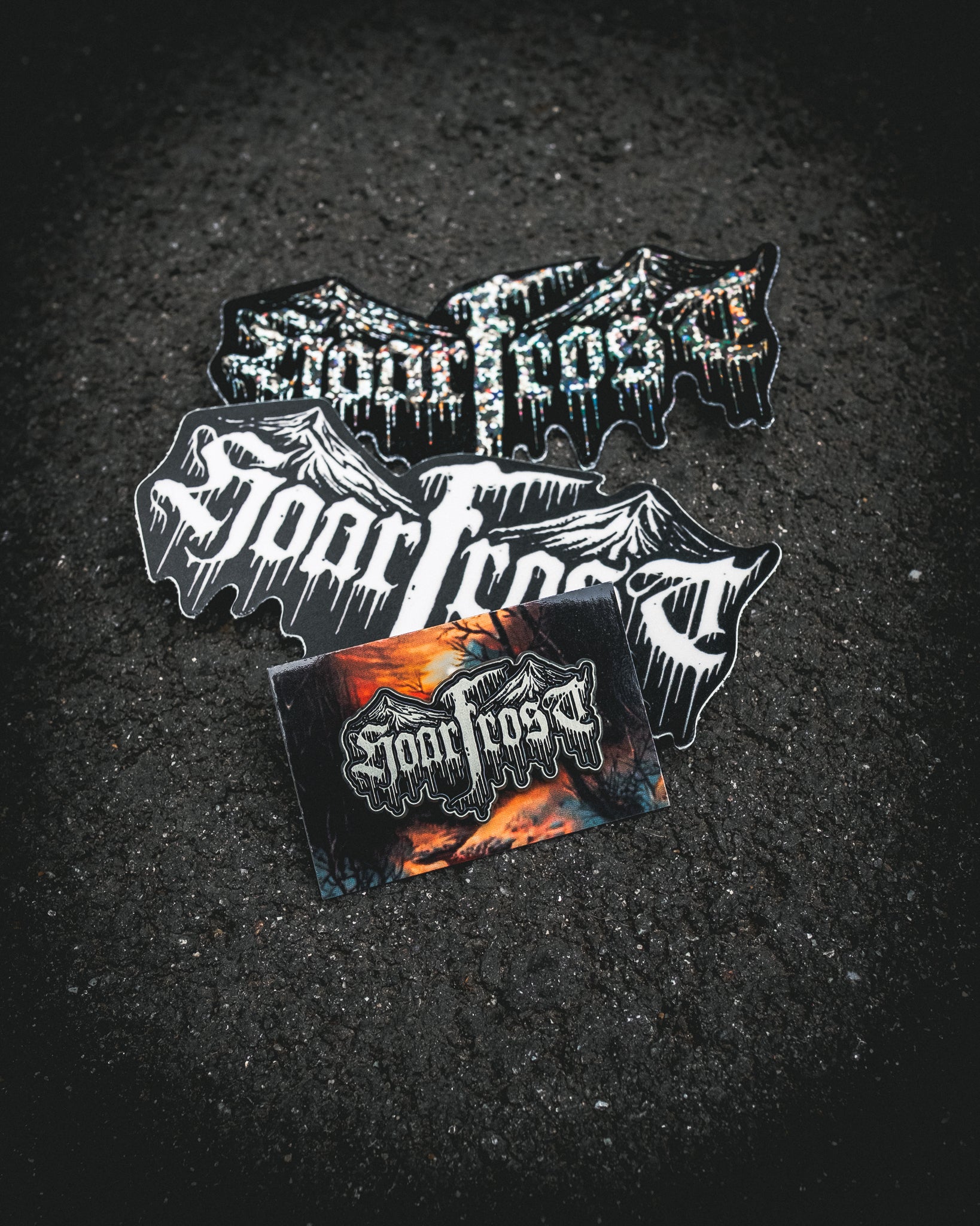 Collection of 'Hoarfrost' branded stickers and an enamel pin by Nick Filth