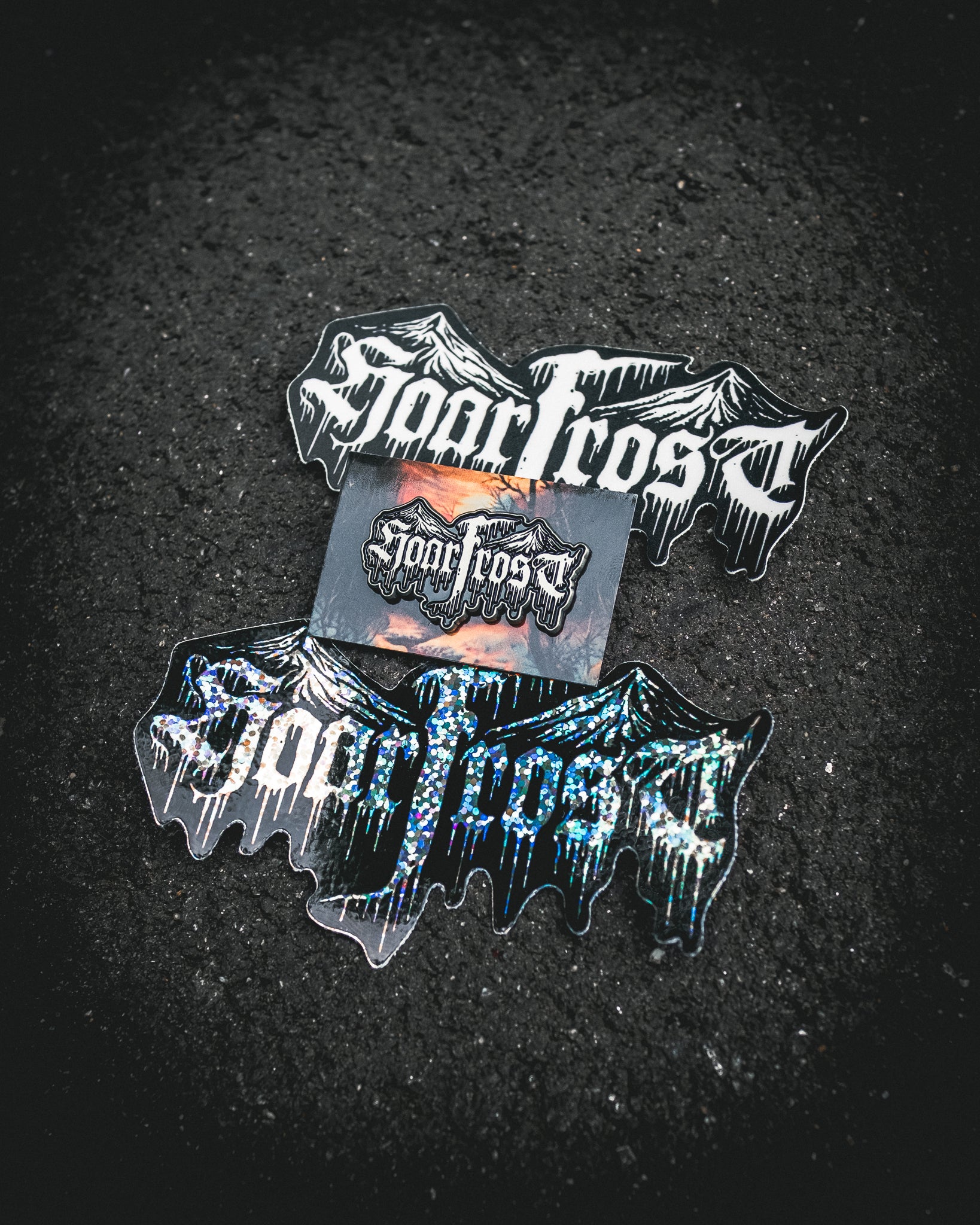Collection of 'Hoarfrost' branded stickers and an enamel pin by Nick Filth