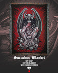 Succubus blanket with tassled edges on a dark background by Nick Filth